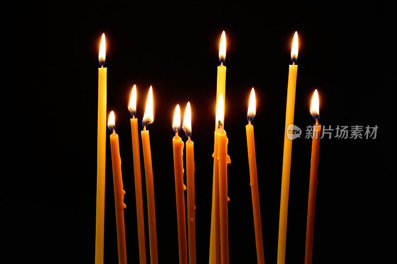 许多燃烧的教堂蜡烛在黑暗的背景