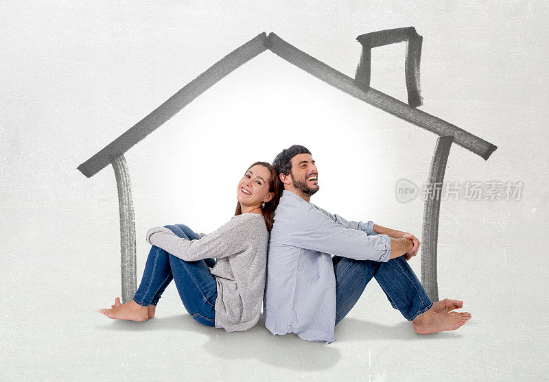 年轻夫妇想象他们的新房子在房地产概念