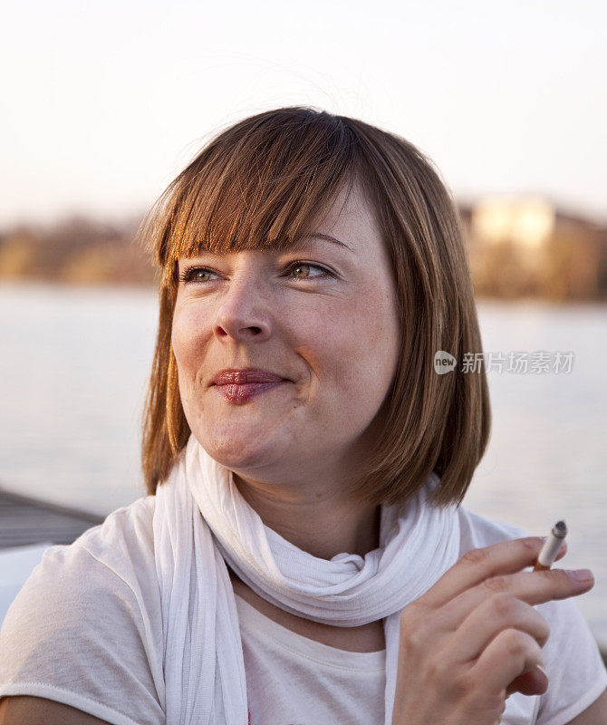 在湖边的画像上抽烟的女人