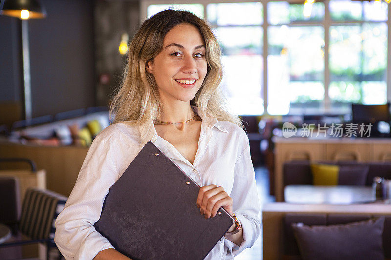 有魅力的女咖啡师在自助餐厅工作的肖像