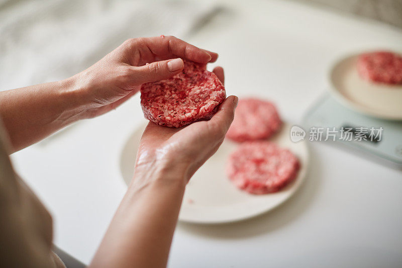 制作汉堡，绞碎的生肉手工塑形。自制的新鲜汉堡肉饼。