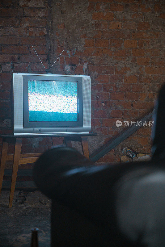 废弃的仓库里有电视，电视静电靠着砖墙