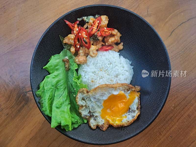 酪乳鸡炒饭，单面朝天，辣椒碎，盐和生菜。食品菜单。前视图。