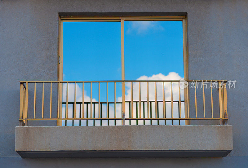 云与蓝天映照在阳台窗前