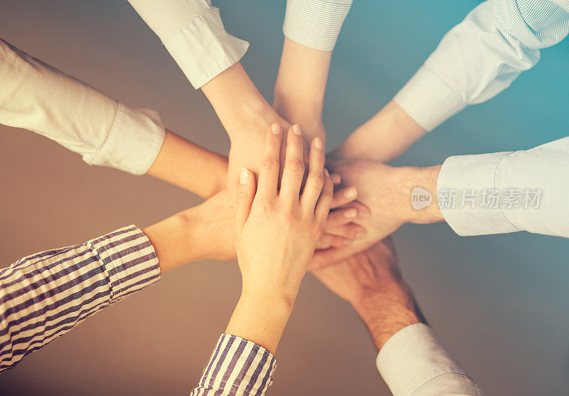 手堆成一堆。是团队合作和信任的象征。