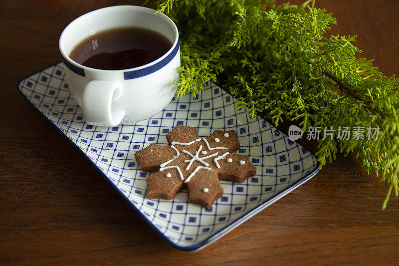 木桌上放着一杯装有圣诞装饰品的茶