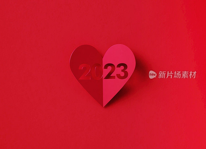 情人节的概念-红色背景上红色裁剪出数字2023心形