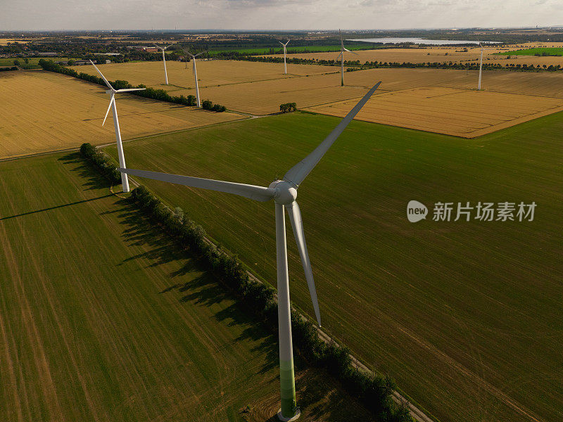 风电场户外摄影。图为农田上的风力发电场。图为风力涡轮机。风电机组，绿色能源理念。可再生能源的风力涡轮机