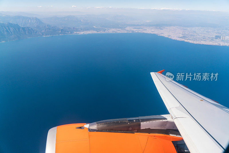 透过飞机窗口可以看到大海和城市