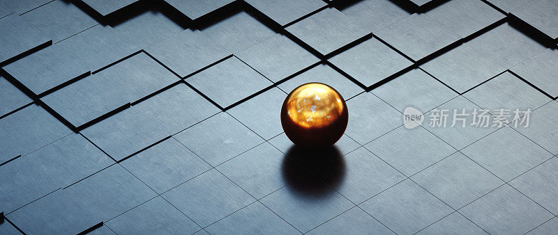 一个单一的金色球体躺在一个深色的拉丝金属表面与砖块形状。
