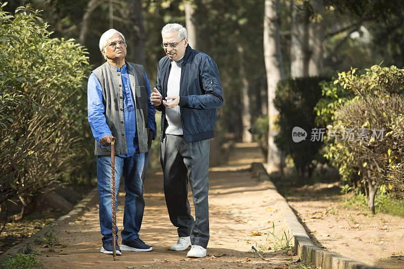 两位年长的男性朋友在公园休闲