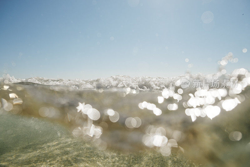 在一个阳光明媚的九月的一天，康沃尔的波斯科诺海滩的海面上和海面下。