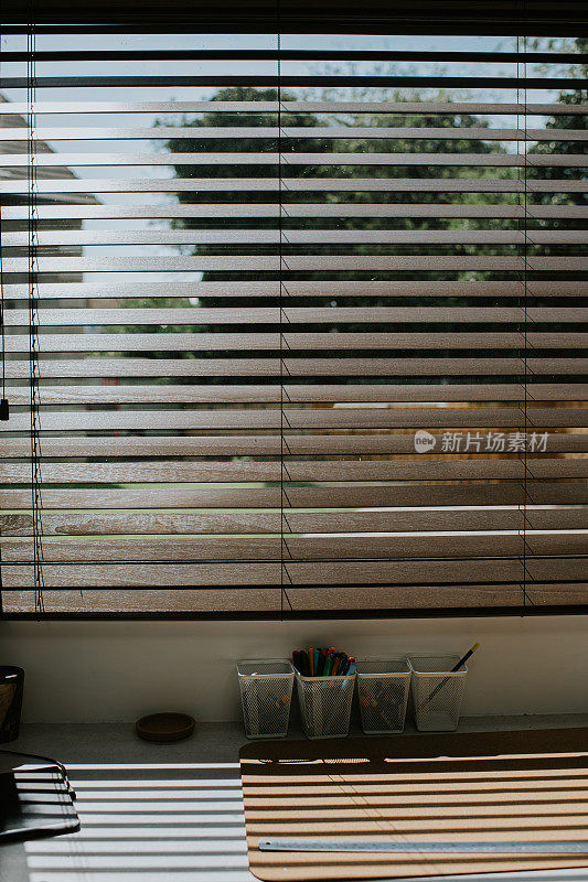 阳光透过高品质的木制百叶窗，进入家庭办公空间
