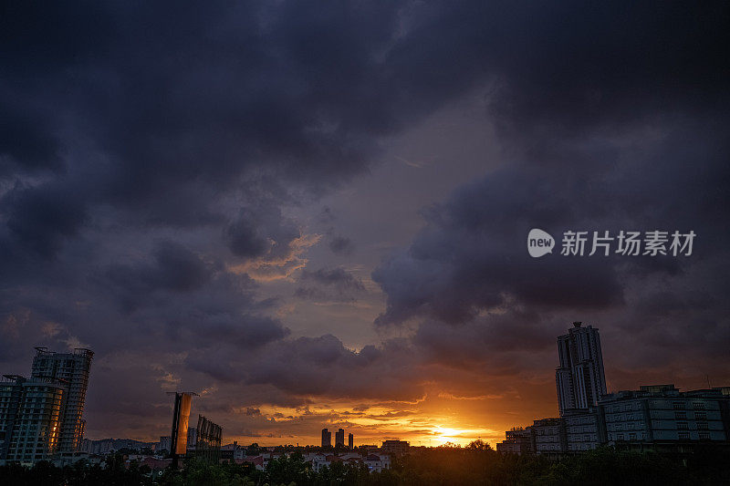 日落时的乡村场景中的暴风雨云聚集