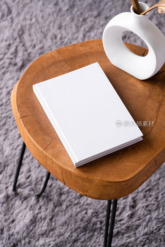 咖啡桌上的空白书模型，有装饰品和灰色地毯