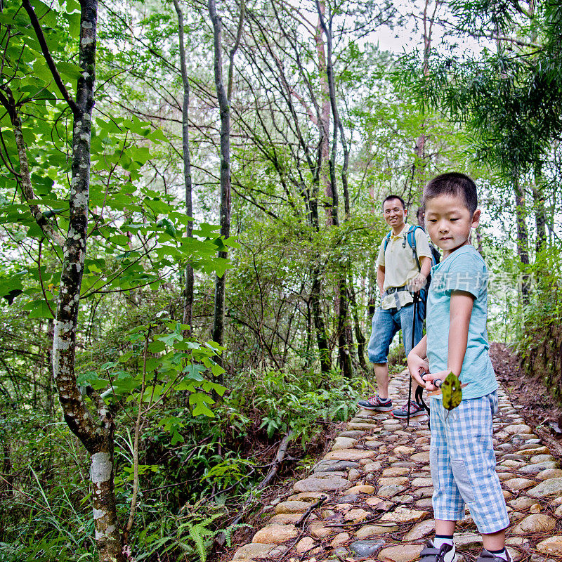 父亲和儿子在森林里徒步旅行