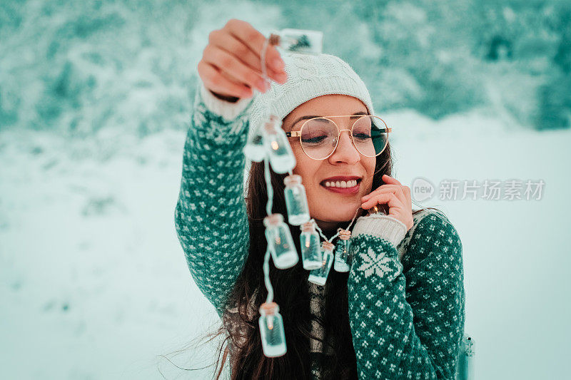 在大自然中拿着新年装饰品的微笑女人