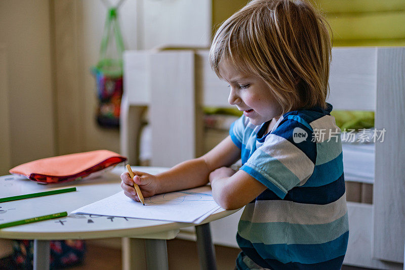 小男孩正在画居家隔离画