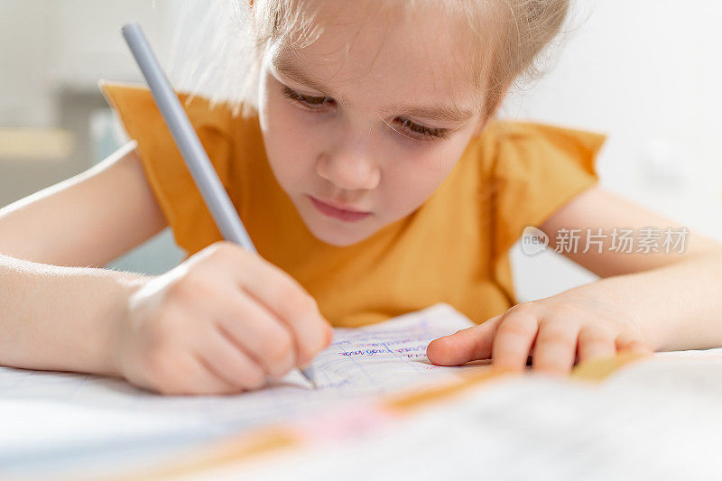 一个全神贯注的小女生在做作业。