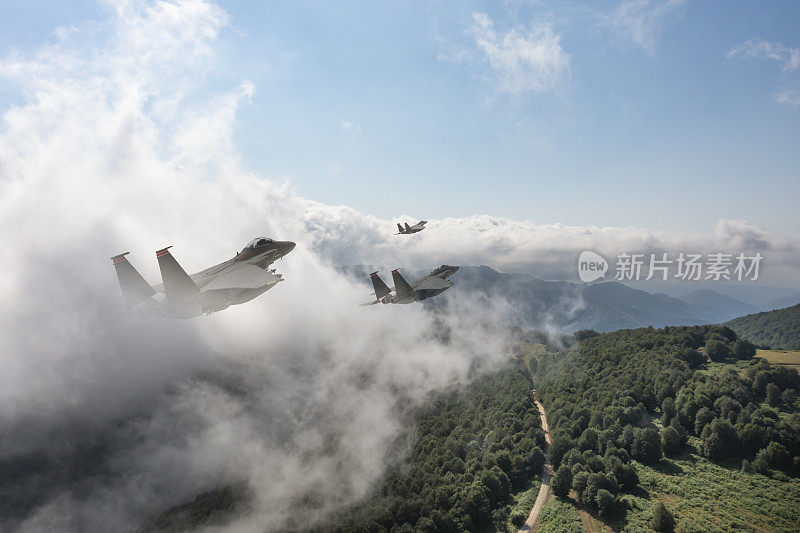 喷气式战斗机飞过群山。