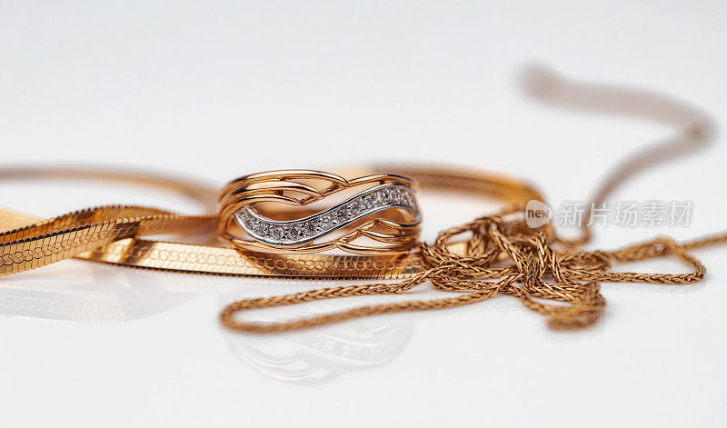 一枚镶有钻石和金项链的金戒指