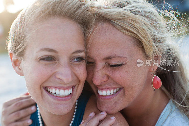 两个女人坐在海滩上有说有笑
