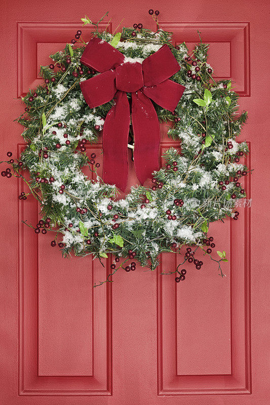 圣诞花环挂在红色的前门