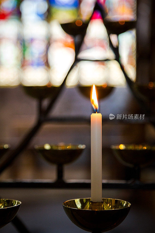 祈祷蜡烛在教堂内排成一排燃烧