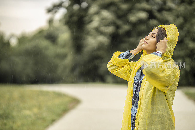 穿着雨衣在雨天行走的女人