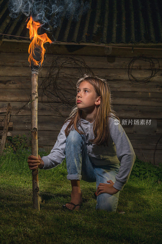 一个拿着燃烧着的火炬的女孩。