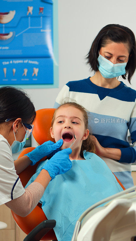 口腔医生为年轻病人检查牙齿健康