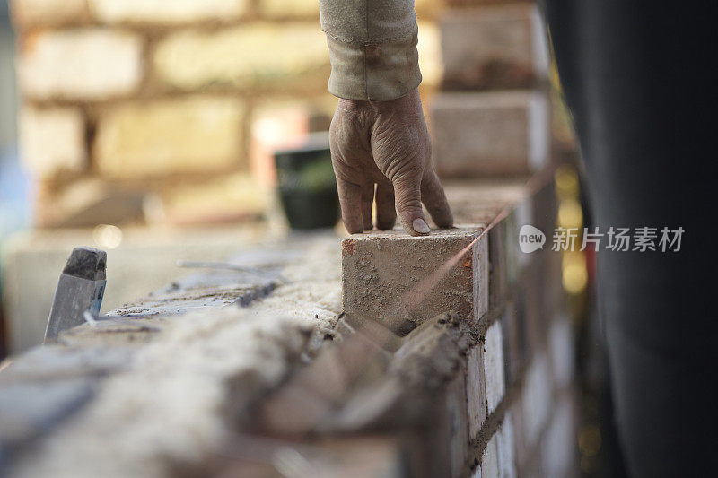 砖匠用再生砖建造新的扩建部分