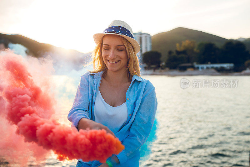 在海滩上玩烟雾弹的女人