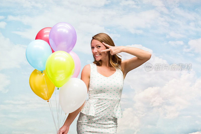 微笑的女人在户外傻乎乎地拿着气球