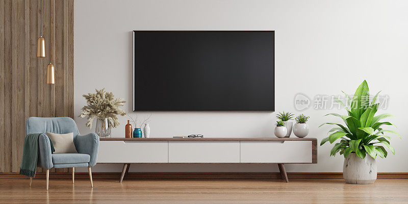 客厅白色墙壁上的智能电视和扶手椅，极简设计。