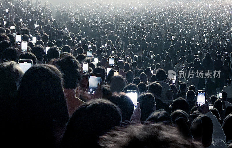 一群人在音乐会上使用手机