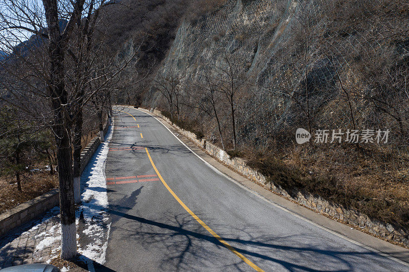 山上积雪覆盖的公路的无人机视图