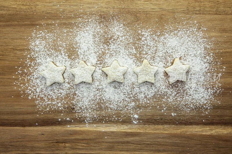 满分5分——用糕点星星和糖粉在木头表面排成一排来表示
