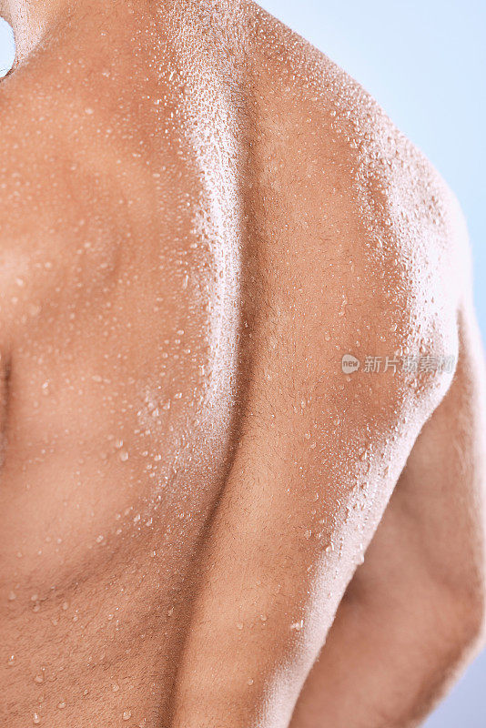 男士，背部和淋浴水滴在皮肤护理，卫生和健康皮肤病学的背景。躯干后面的特写，强壮的男性和潮湿的人体肌肉，解剖清洁和工作室健康