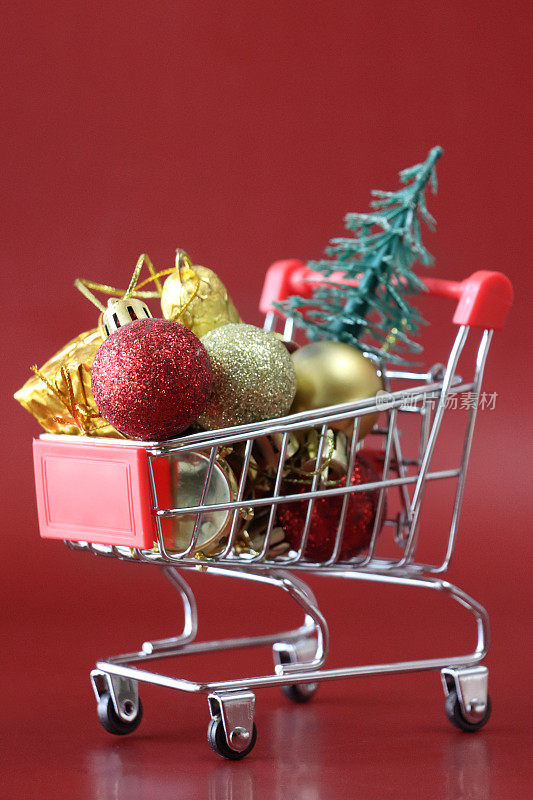 形象的圣诞装饰在微型购物车，圣诞礼物购物，最后一分钟的节日采购