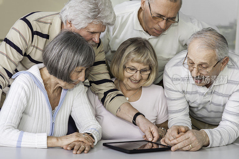 一群老年人正在研究平板电脑
