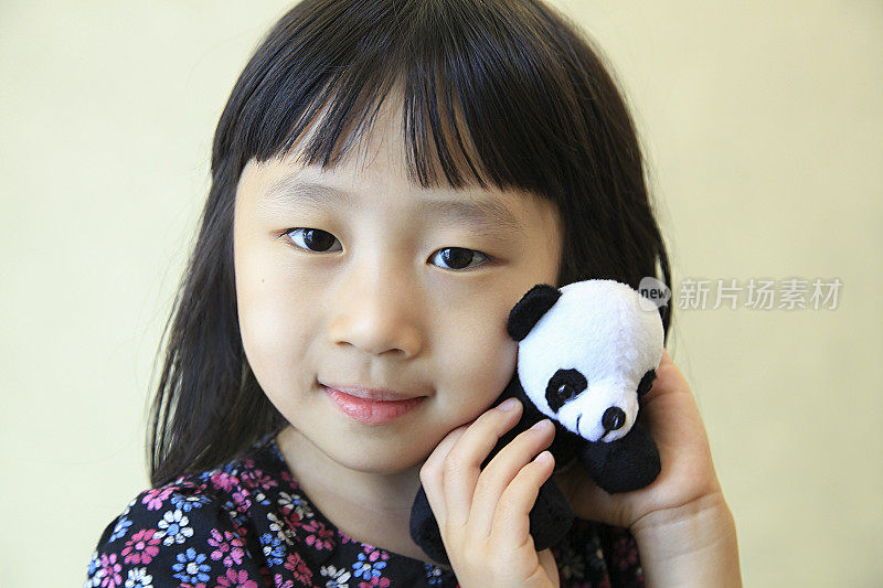 小女孩和她的熊猫玩具
