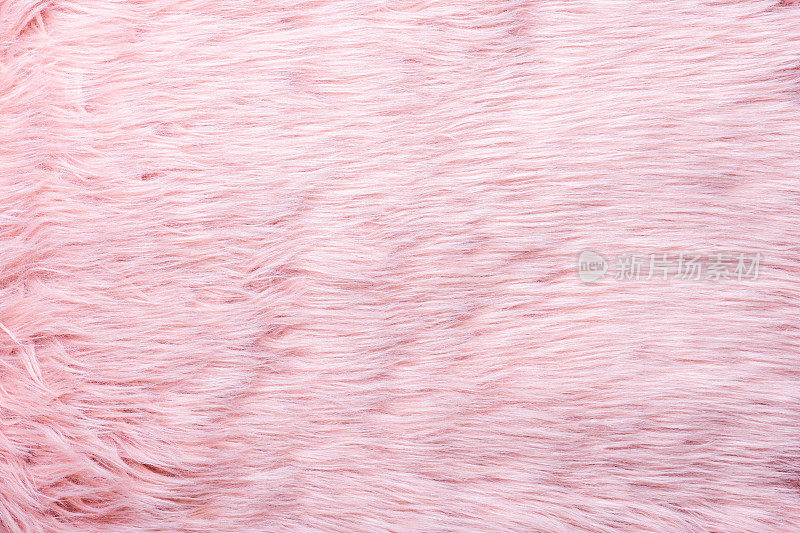 时髦的粉红色人造毛皮质地。毛皮图案俯视图。粉色皮草背景。粉红色蓬松毛的质地。羊毛质地。Flaffy羊皮
