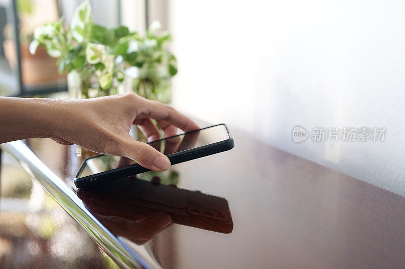 一只手从桌子上拿起手机的剪辑镜头。