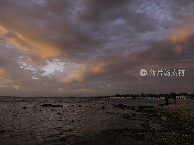 海滩和城市天际线上戏剧性的云层