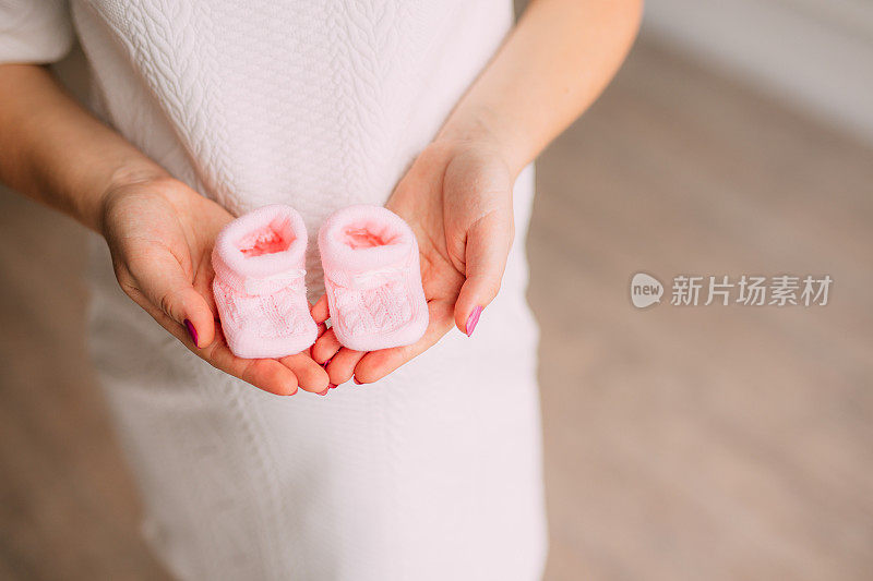 孕妇手中的婴儿鞋