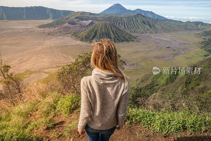 年轻女子徒步旅行沉思火山景观从山顶看布罗莫火山-人们旅行冒险的概念