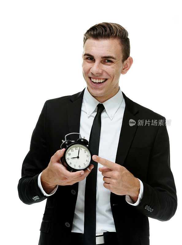 兴高采烈的商人拿着钟和显示时间