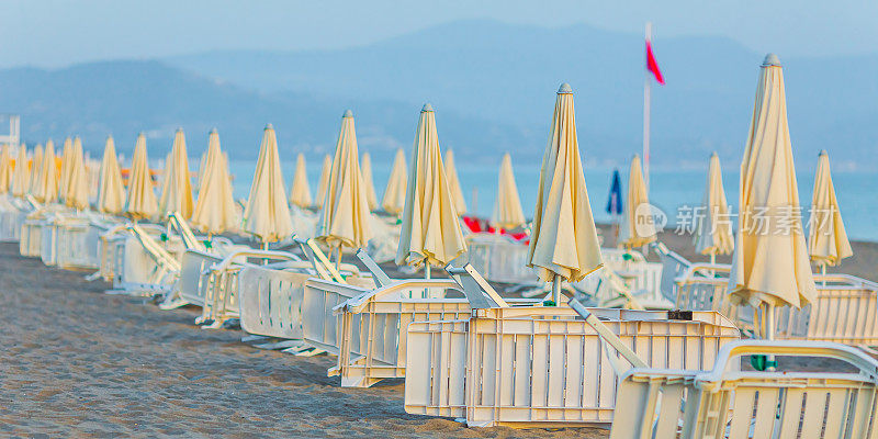 躺椅和海边的沙滩伞。Agropoli。意大利。第勒尼安海。夏天