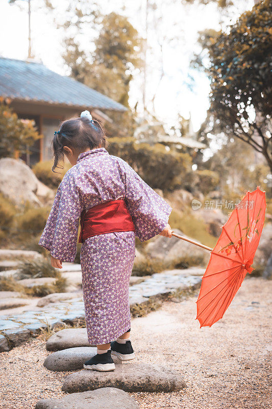 和服的宁静:一对中国双胞胎幼儿在日本公园散步和放松